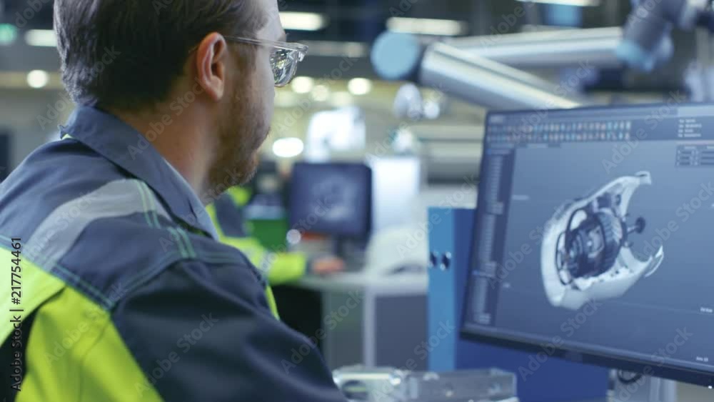 Poster At the Factory: Team of Mechanical Engineers Works on Computers, Designing in 3D Model of the Engine using CAD Software. Shot on RED EPIC-W 8K Helium Cinema Camera.