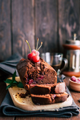 Chocolate cake with cherries on a dark wooden background, dessert, baked goods