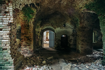 Inside ancient ruined medieval brick temple interior with arches and corridors