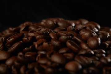 grains of coffee with smoke on a dark background