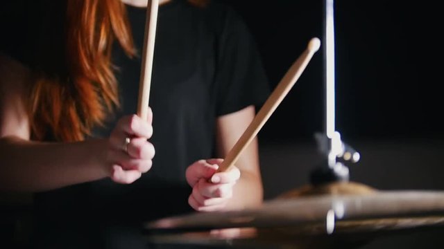 Girl with red hair playing drums
