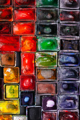 Flat lay photo of used water-color paint-box