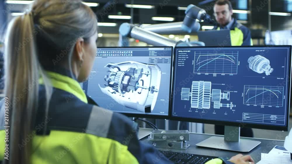 Poster At the Factory: Female Mechanical Engineer Designs 3D Engine on Her Personal Computer while Male Automation Engineer Uses Laptop for Programming Robotic Arm.