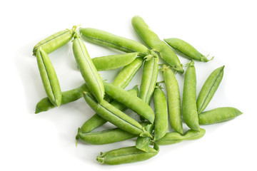 Pods of green peas on a white background.