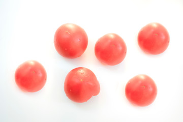 Red tomatoes on a white background.
