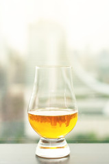 Exclusive Scotch whisky next to windows sky view with blur city background