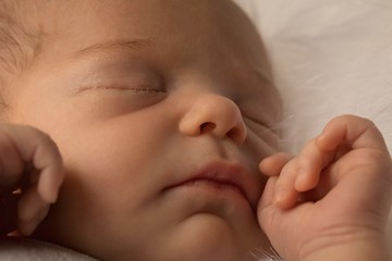 Newborn baby sleeping on baby bed