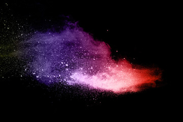 Abstract multi color powder explosion on black background.  Freeze motion of color dust  particles splash. Painted Holi in festival.