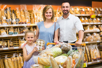 Family buying bread in food store.