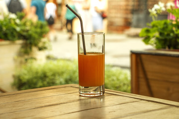 Fresh orange juice with mint in a glass bowl on a dark plate. Orange juice on a dark background, top view, copy space.