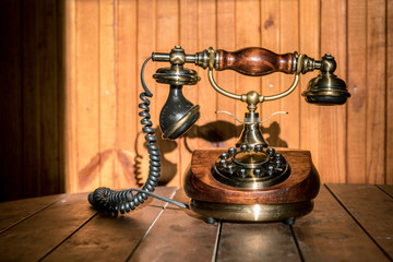 Vintage telephone at wooden background