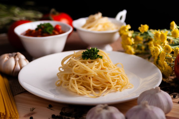Boiled spaghetti in white plate with many ingredients prepare for cooking. Food stylish set up for advertisement.