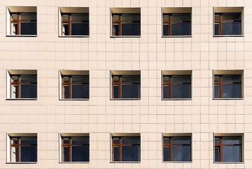 Square Windows of the building on a yellow background, lots of Windows