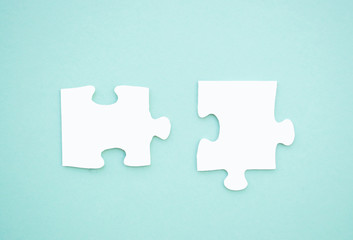 Fototapeta premium Puzzle pieces on blue background. Autism awareness day.