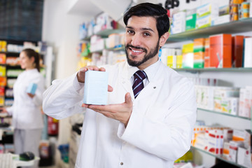 Fototapeta na wymiar pharmacist standing with medicine on his work place