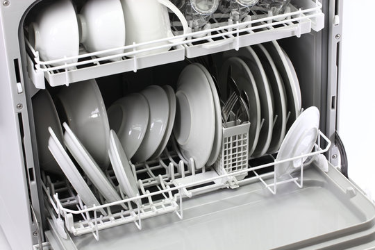 Open Dishwasher With Clean Dishes Isolated On White Background