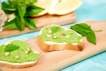 Bruschetta with pesto sauce, parmesan cheese and fresh basil