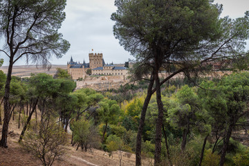 Fototapeta na wymiar Landscape from a pine forest with the Alcazar de Segovia in the background. Spain.