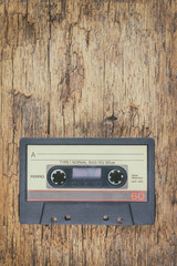 Old audio compact cassette on wood