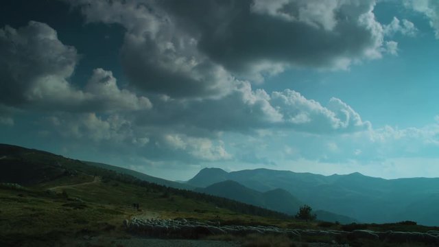 White clouds rolling above the mountains. A timelapse.