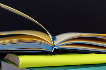 Stack of colorful books on wooden desk. Copy space for text. Back to school. Education background