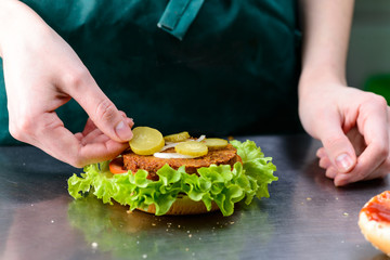 chief adds fresh vegetables to vegetarian burger made from soy