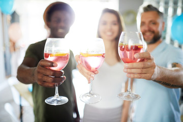 Human hands with homemade fruit cocktails during toast for friendship