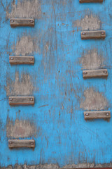 old Wooden wall for climbing close up. Sports extreme blue and grey background