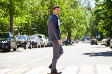 Portrait in full growth of a young man in a business suit