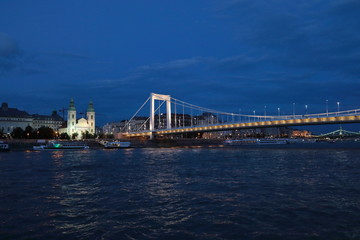 Panoramic views of night bridges through Danube with illumination.