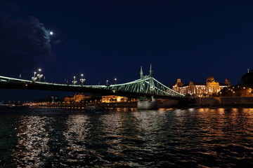 Fototapeta na wymiar Panoramic views of night bridges through Danube with illumination.