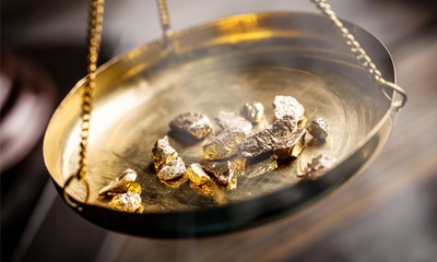Small gold nuggets in an antique measuring