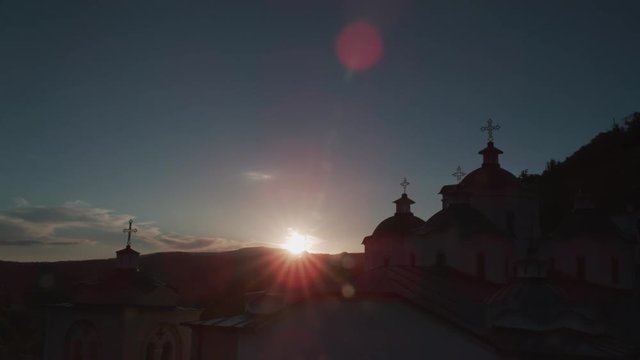 Timelapse of the sun setting over an orthodox church