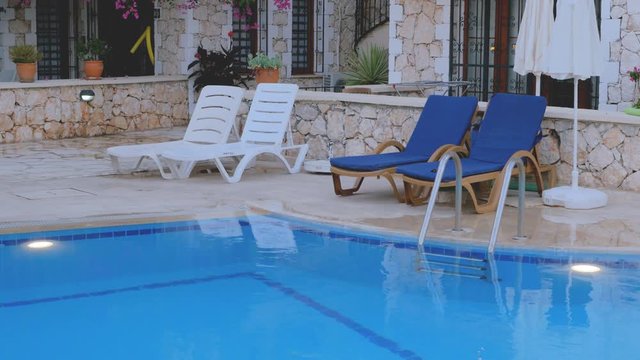 Beach chairs near swimming pool