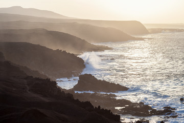 Scenic view of mountains and atlantic ocean on sunset