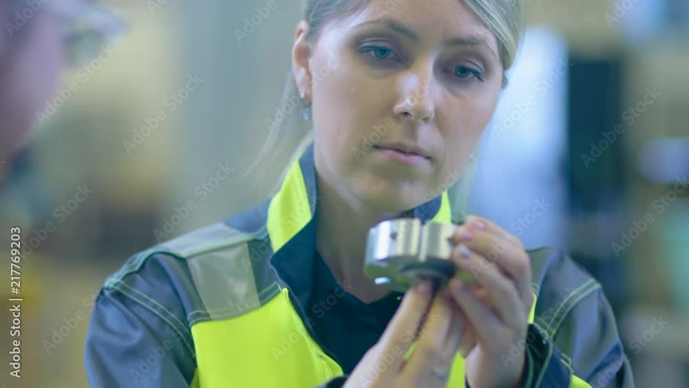 Poster Close-up Shot of the Industrial Engineer Testing Quality of the Component Made by Mechanical Engineer. Professionals Wear Protective Clothing and Discuss High Precision Mechanical Engineering.