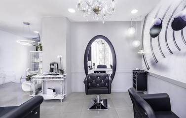Modern bright beauty salon or baber shop. Hair salon interior business with black and white luxury decor.