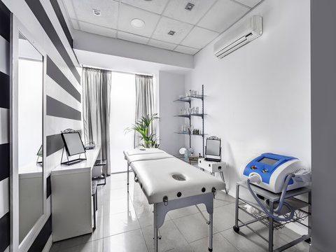 View of an Interior of a modern clean massage room with black and white luxury decor.