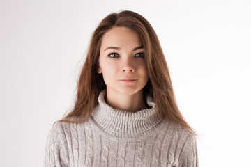 Portrait of a young attractive girl in casual cloth on white studio background