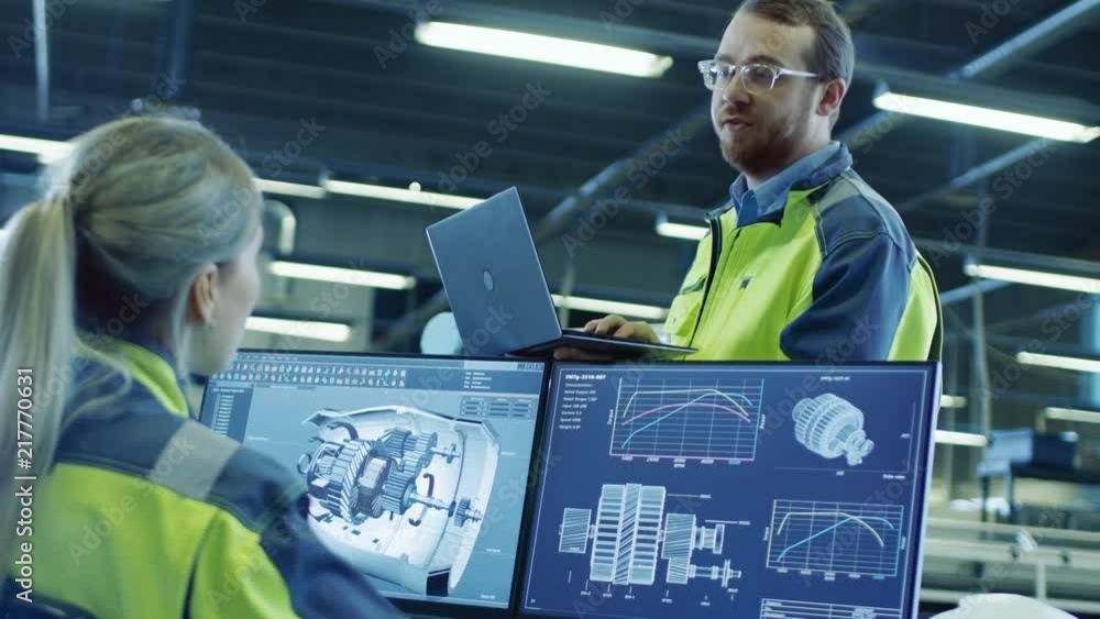 Poster At the Factory: Male and Female Mechanical Engineers Use Laptop and Personal Computer while Talking. Screen Shows 3D Engine Concept made with CAD Software.