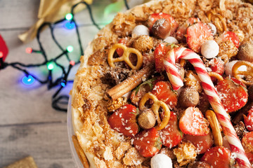 Napoleon cake with fresh berries and Christmas candy.
