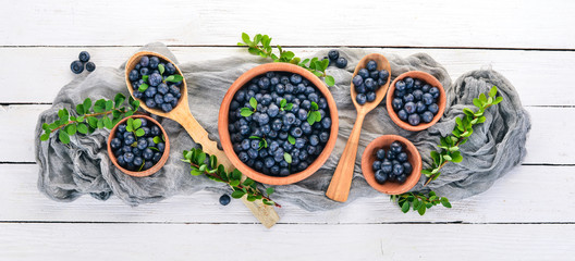 Fresh berries of blueberries. On a wooden background. Top view. Free space for your text.