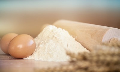 Fototapeta na wymiar Wheat ears with egg and flour