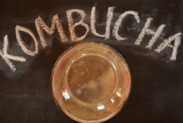 fermented drink, jun tea healthy natural probiotic in a glass jar.