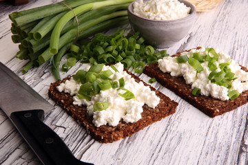 Cream Cheese on a slice of bread topped with fresh green onions or spring onions