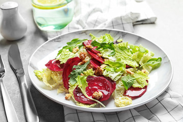 Plate with delicious beet salad served on table