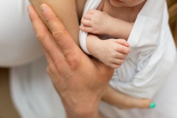 Obraz na płótnie Canvas A newborn baby squeezed his mother's fingers