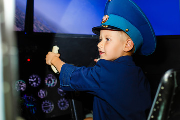 A happy, kindergarten boy toting in an oversized airline pilot uniform © Angelov