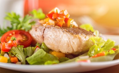Delicious fried meat with salad on plate,