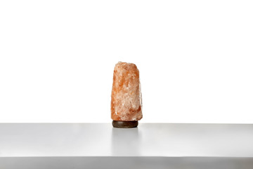 Exotic Himalayan salt lamp on white background